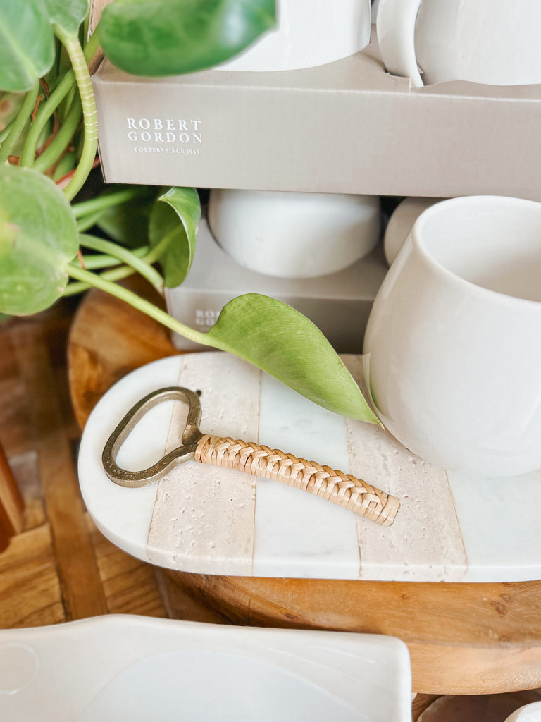 Gold bottle opened with a bamboo handle. 